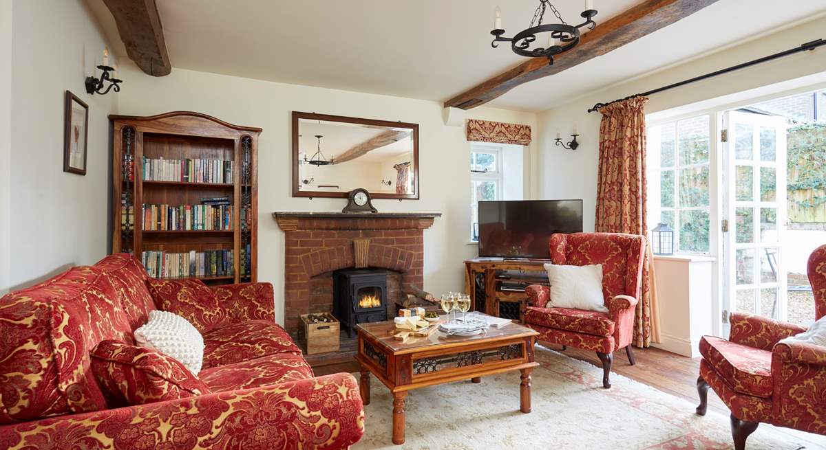 The large sitting-room with French doors leading onto the terrace to enjoy summer sun or light the wood-burner in the cooler months.