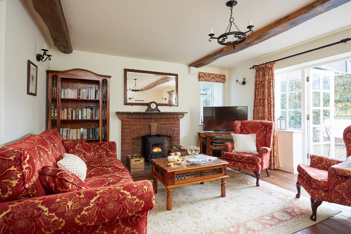 The large sitting-room with French doors leading onto the terrace to enjoy summer sun or light the wood-burner in the cooler months.