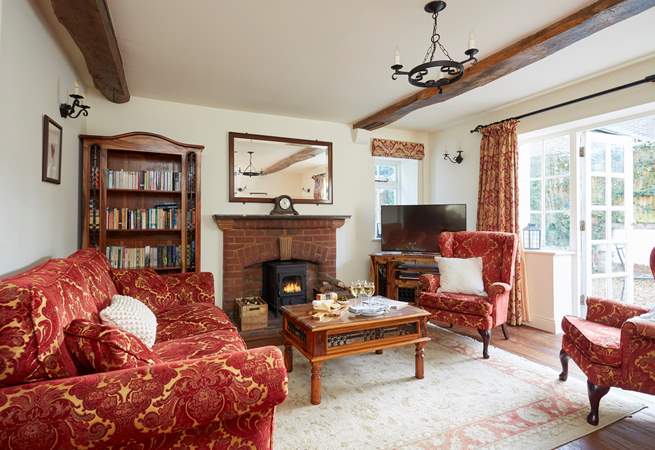 The large sitting-room with French doors leading onto the terrace to enjoy summer sun or light the wood-burner in the cooler months.