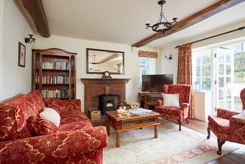 The large sitting-room with French doors leading onto the terrace to enjoy summer sun or light the wood-burner in the cooler months.