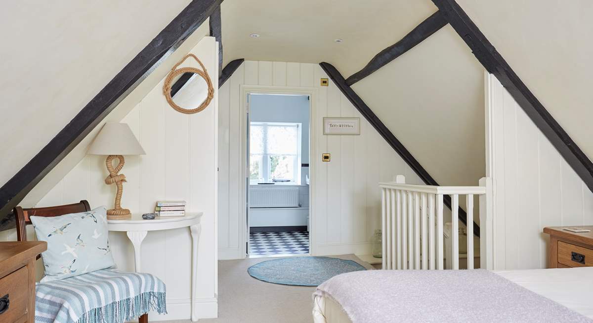 A view from the main bedroom through to the en suite bathroom.