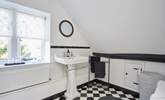 The en suite bathroom with windows overlooking the front of the property and garden. - Thumbnail Image