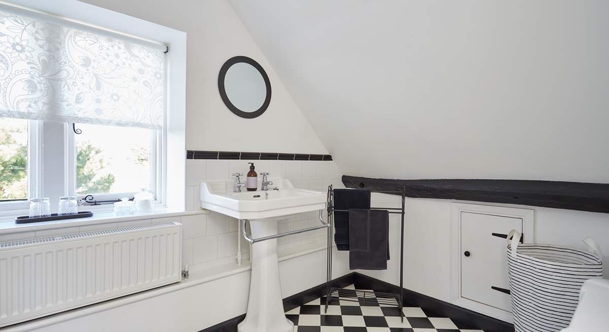 The en suite bathroom with windows overlooking the front of the property and garden.