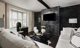 The stylish sitting-room with its striking monochrome design. - Thumbnail Image