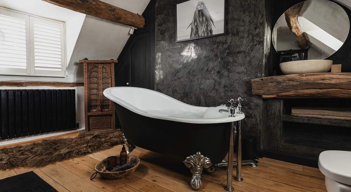 The en suite to the main bedroom has an elegant roll-top bath and stunning interior design.