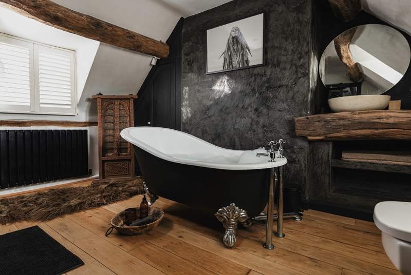The en suite to the main bedroom has an elegant roll-top bath and stunning interior design.