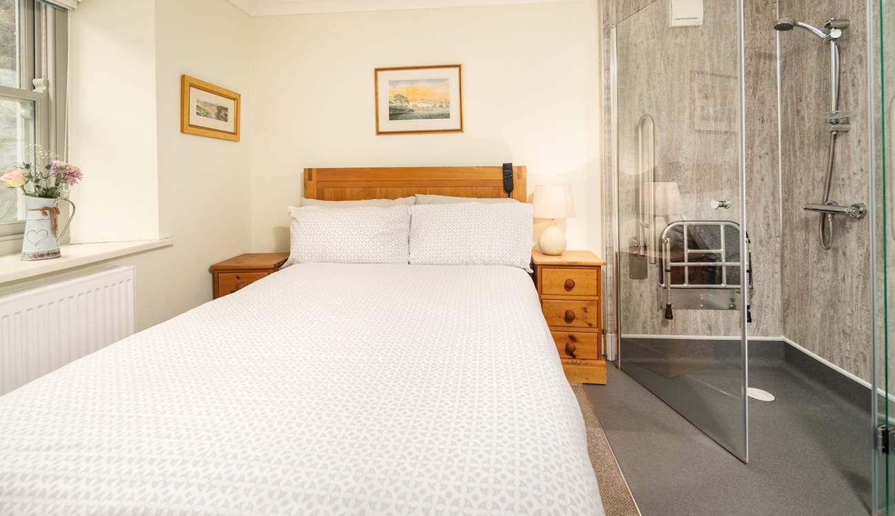 Ground floor bedroom offering a mobility bed and wet-room shower. 