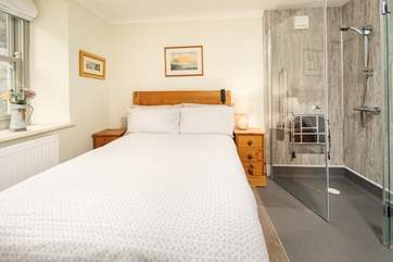 Ground floor bedroom offering a mobility bed and wet-room shower.