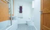 The modern family bathroom with lovely bright tiles. - Thumbnail Image