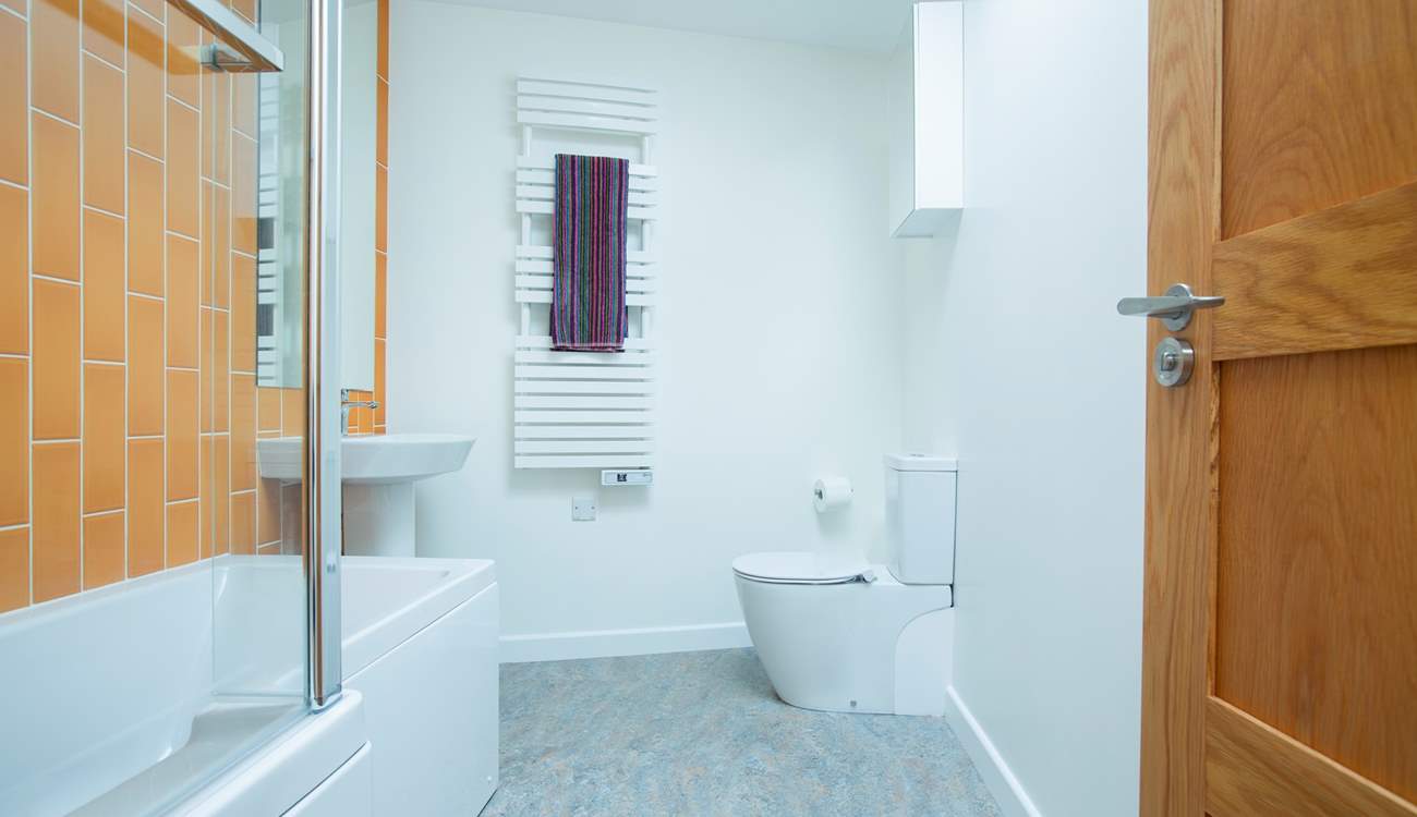The modern family bathroom with lovely bright tiles.
