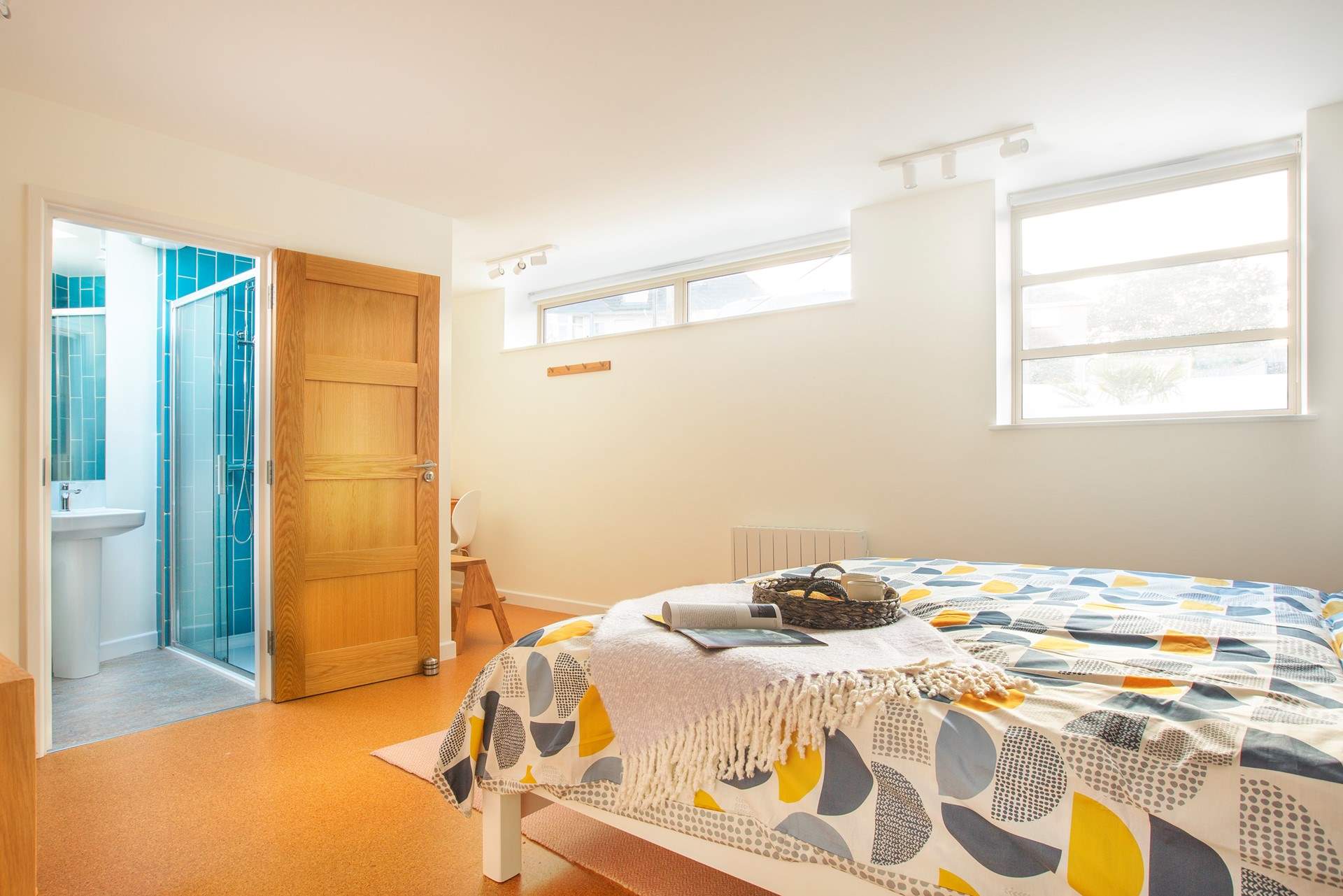 The bright and spacious bedroom three with a writing nook to one corner and en suite shower-room.