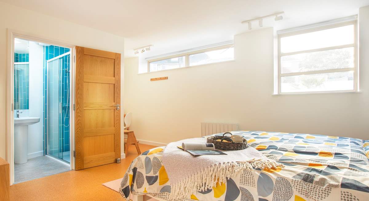 The bright and spacious bedroom three with a writing nook to one corner and en suite shower-room.