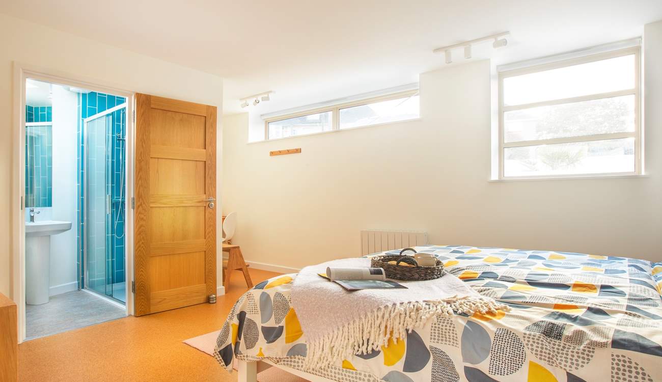 The bright and spacious bedroom three with a writing nook to one corner and en suite shower-room.