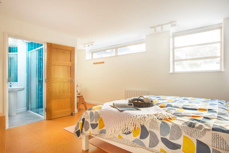 The bright and spacious bedroom three with a writing nook to one corner and en suite shower-room.