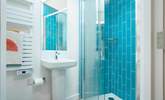 The en suite shower-room with vibrant blue tiles and a cleverly fitted skylight. - Thumbnail Image