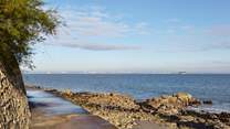 Footpath along the waters edge at Seaview with view of Portsmouth in the distance.