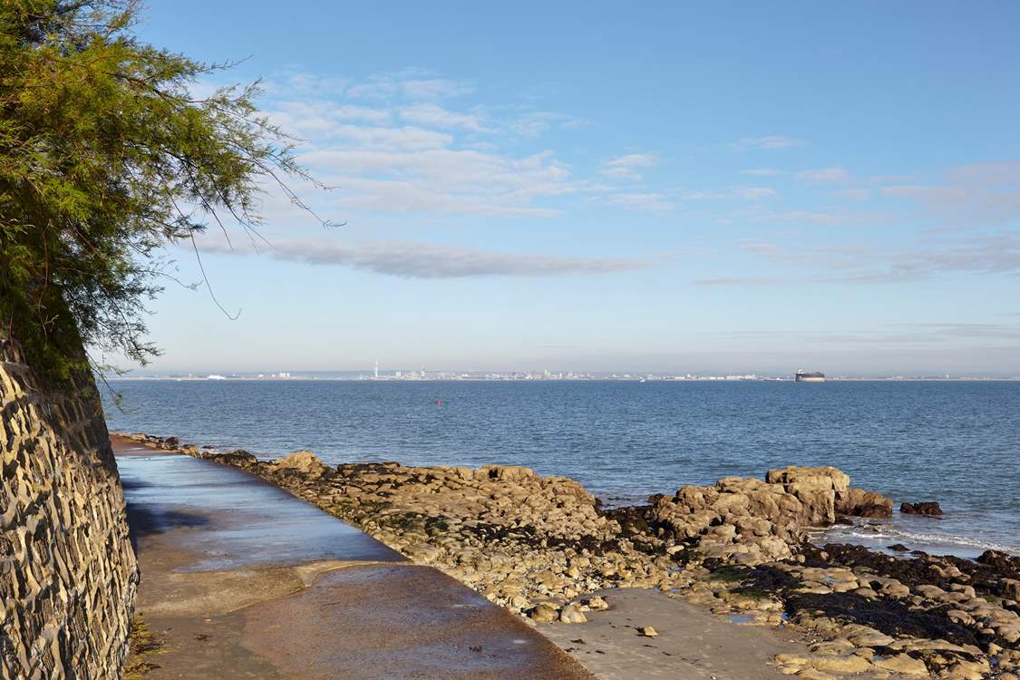 Footpath along the waters edge at Seaview with view of Portsmouth in the distance.