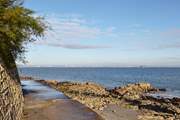 Footpath along the waters edge at Seaview with view of Portsmouth in the distance.