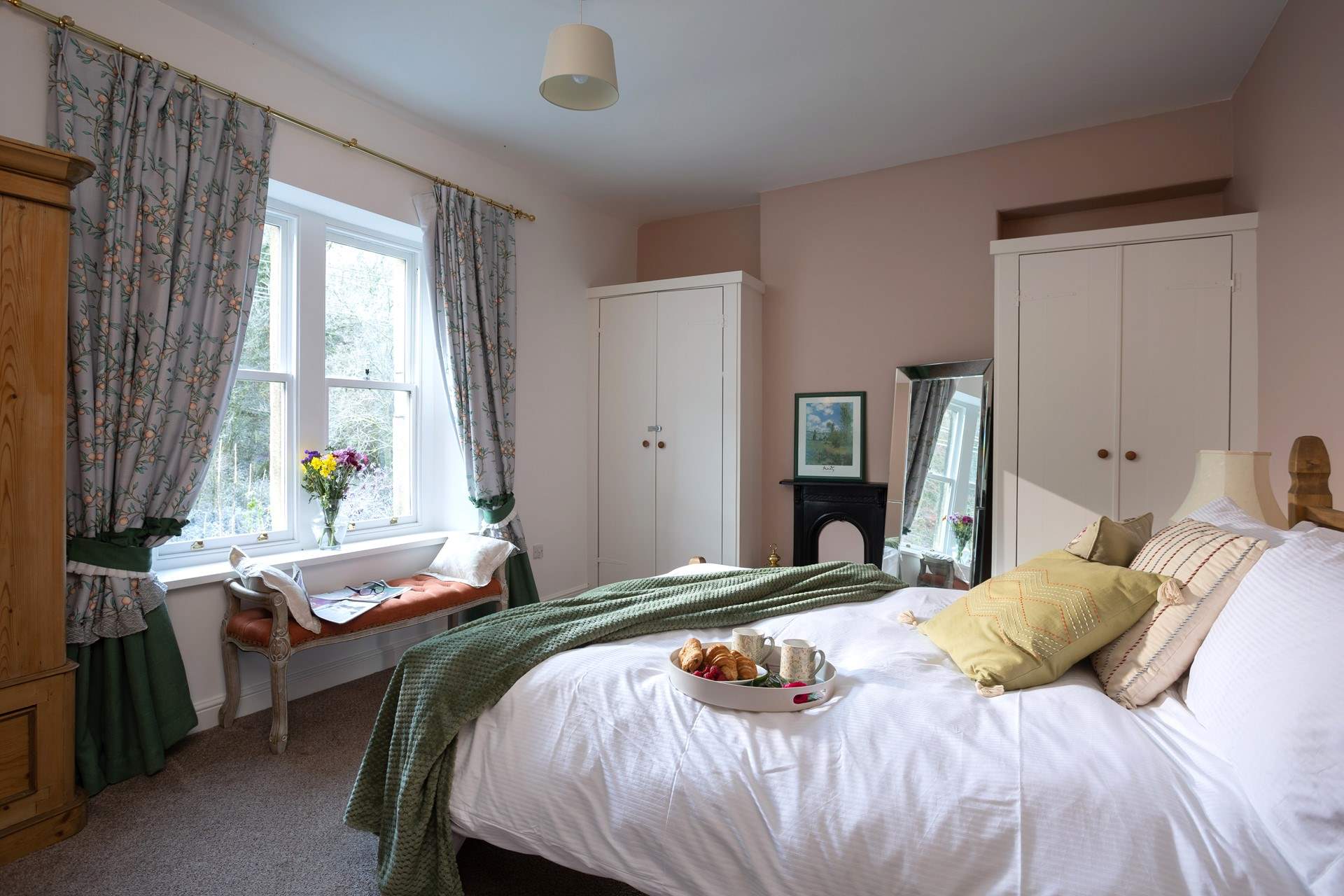 A beautiful bedroom with a view over the river.