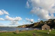 Walk to Cwm yr Eglws at low tide or follow the coast path, a sheltered cove with a sandy beach and rock pools. What remains of St. Brynach's Church after the Great Storm still stand on the beach front.