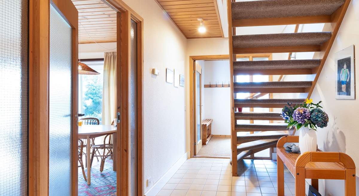 Climb the open tread staircase to the two further bedrooms, shower-room and very useful second sitting-room/snug where you'll find a TV, lots of games and a table and chairs. Children will love this space.