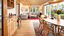 Commanding an enchanting position with sea views, the versatile accommodation sleeps eight over two floors. 