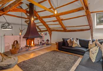 The stairs to the lower ground floor are accessed via the right-hand side of the fireplace.