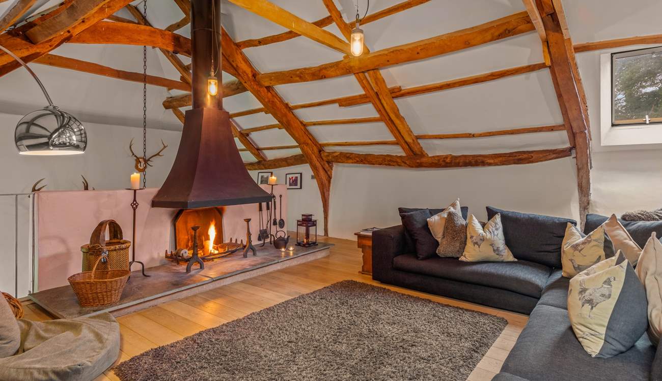 The stairs to the lower ground floor are accessed via the right-hand side of the fireplace.