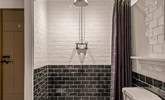 For those who prefer a shower, the family bathroom offers a beautiful shower space. - Thumbnail Image