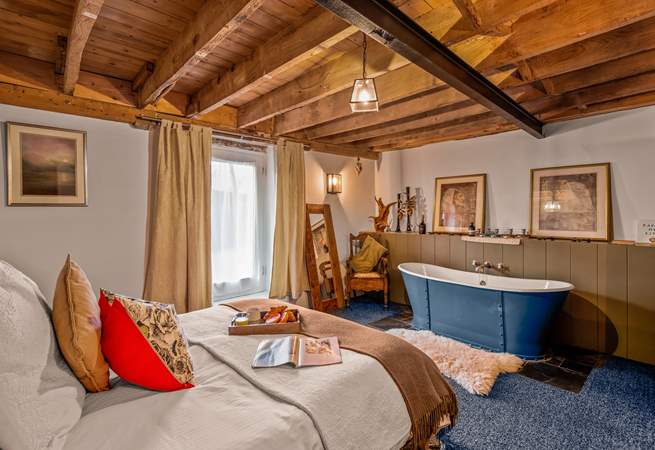 Bedroom one is home to a king-size bed and this glorious roll-top bath.