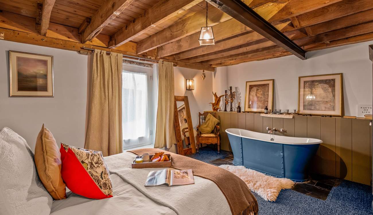 Bedroom one is home to a king-size bed and this glorious roll-top bath.