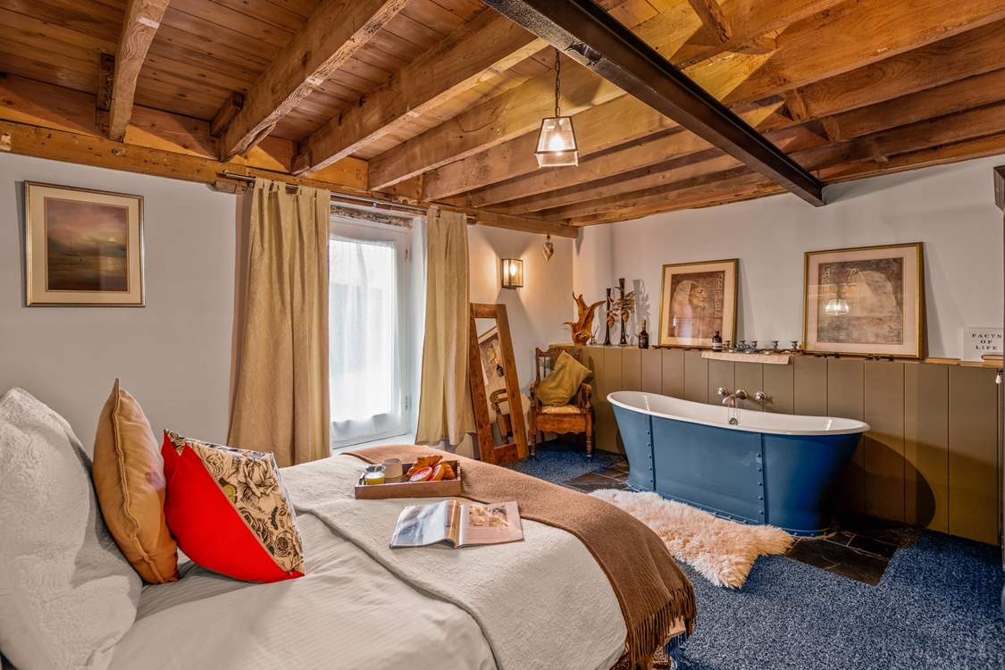 Bedroom one is home to a king-size bed and this glorious roll-top bath.