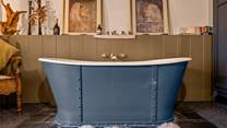 Jump out of bed, straight into your roll-top bath which sits proudly at the foot of your bed.