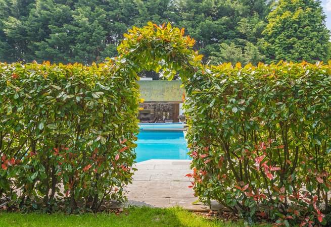 Step through the hedge to your privately enclosed swimming pool area.