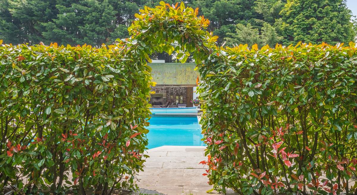 Step through the hedge to your privately enclosed swimming pool area.