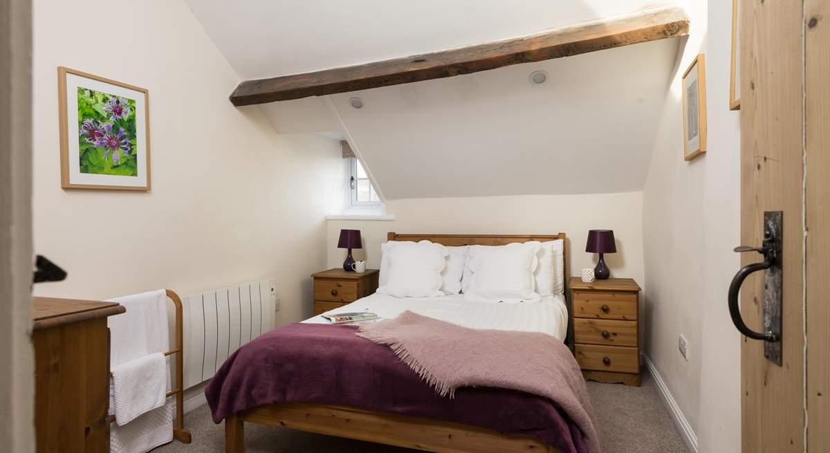 Another comfy bedroom with beams.