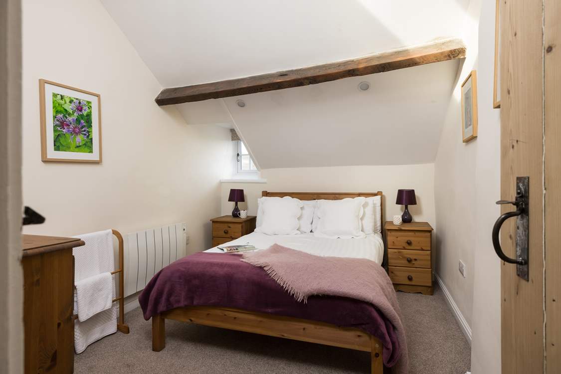 Another comfy bedroom with beams.