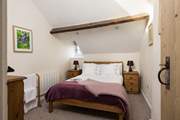 Another comfy bedroom with beams.