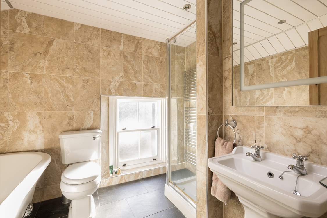The modern bathroom has a free-standing bath.