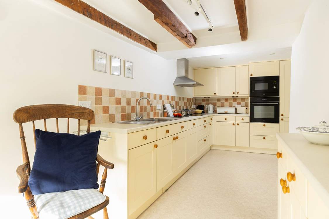 This modern kitchen in a grand old farmhouse is fully equipped. 