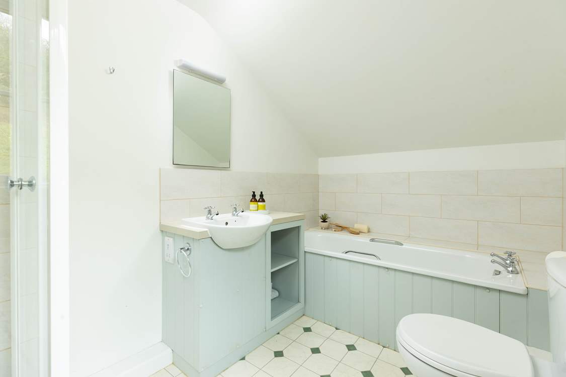Off the split-level landing between bedrooms one and two, you will discover the first of two bathrooms. Benefiting from both a shower cubicle and bath it's the perfect set up for a multi-generational family.