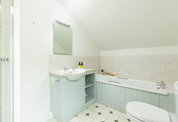 Off the split-level landing between bedrooms one and two, you will discover the first of two bathrooms. Benefiting from both a shower cubicle and bath it's the perfect set up for a multi-generational family. 