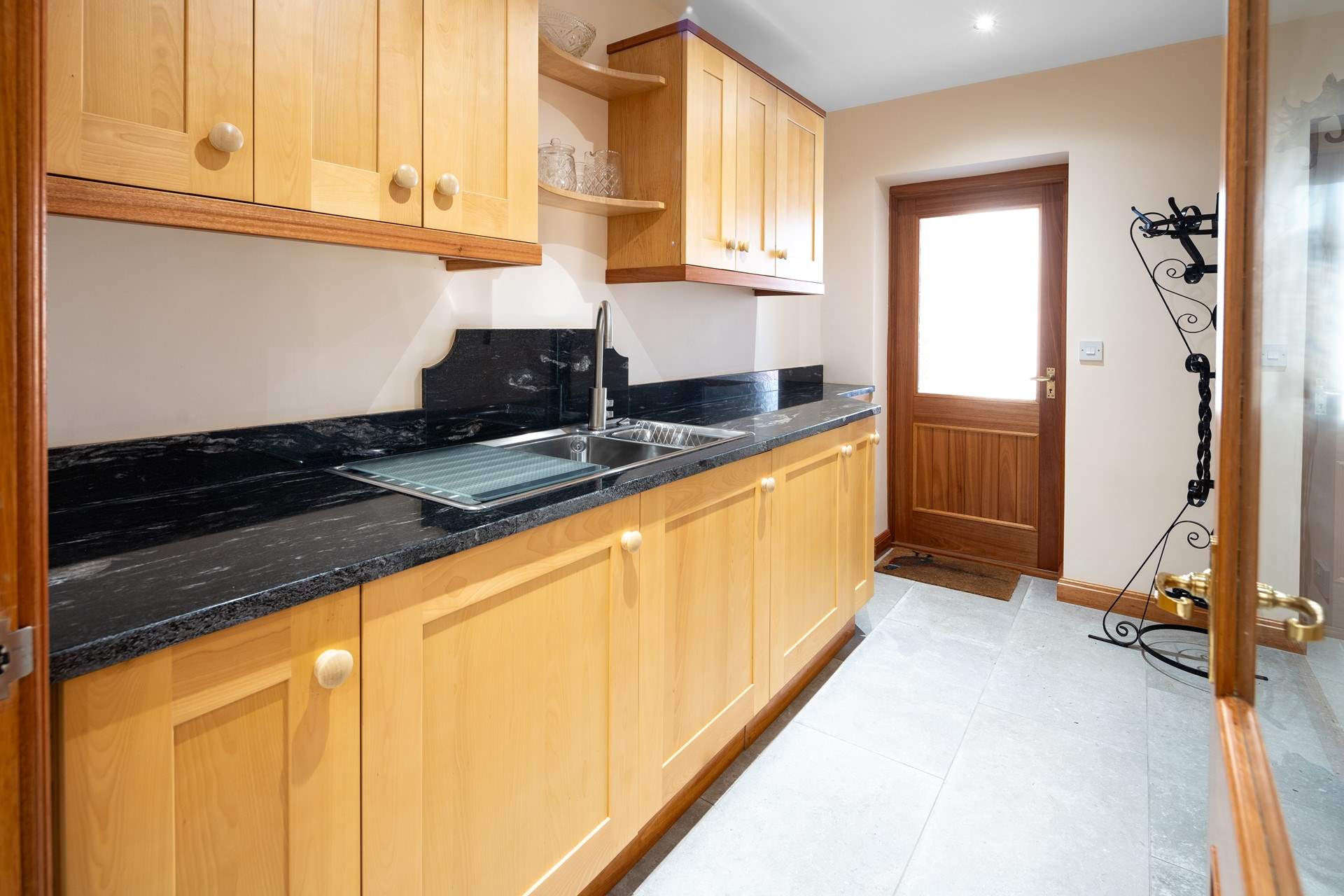 Utility-room for muddy boots and coats with washing machine and plenty of cupboard space. 