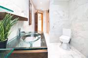 Sleek shower-room with designer wash-basin and hydro-massage steam shower.