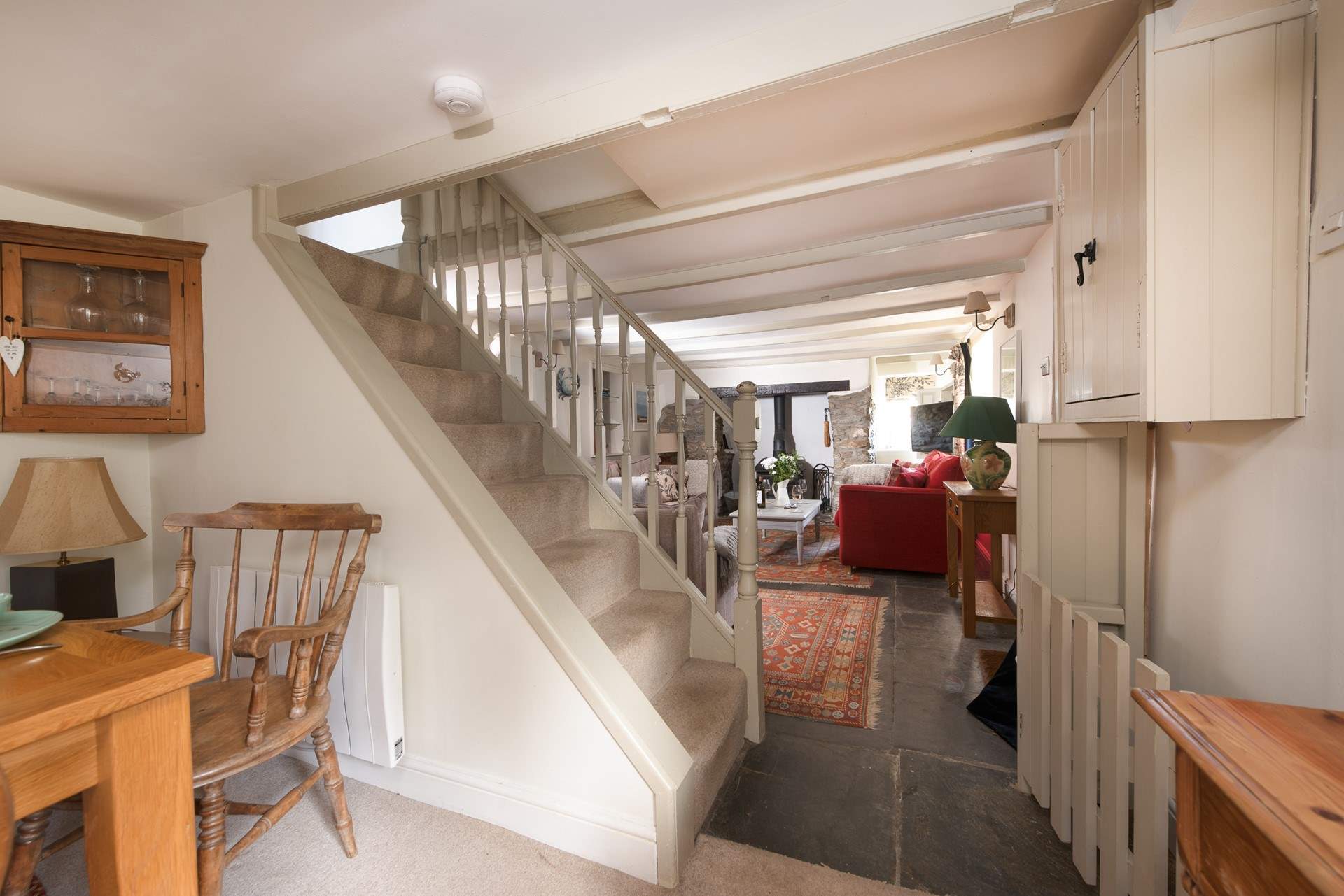 The steep open stairs lead to three bedrooms and family bathroom.