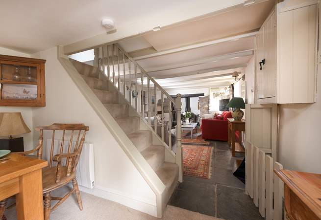 The steep open stairs lead to three bedrooms and family bathroom.