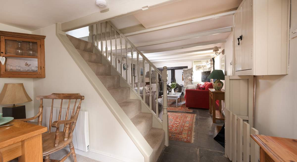 The steep open stairs lead to three bedrooms and family bathroom.