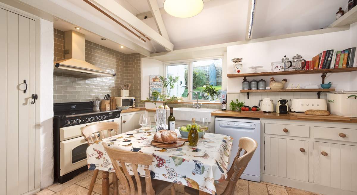 The light and spacious kitchen is designed in a classic farmhouse style.