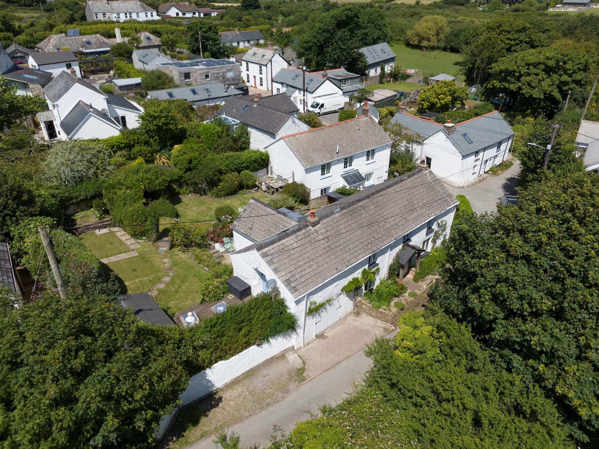 Old Kiddlywinks has a lovely large garden to relax in, you can see the parking for two cars to the left of the cottage. 