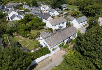 Old Kiddlywinks has a lovely large garden to relax in, you can see the parking for two cars to the left of the cottage. 